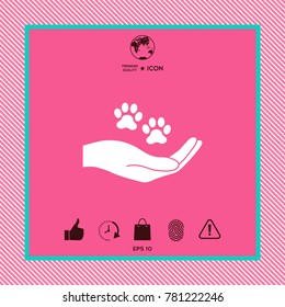 Hand holding paw symbol. Animal protection