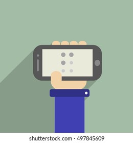 Hand holding a phone with "F" letter in Braille