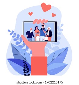 Hand holding phone with family photo on screen flat vector illustration. Picture of parents, grandparents and children on smartphone. Digital technology and relations concept