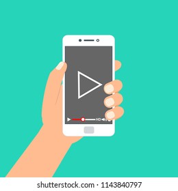 Hand holding phone icon. Vector illustration. There is a "play" button on the display of the smartphone in the picture