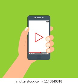 Hand holding phone icon. Vector illustration. There is a "play" button on the display of the smartphone in the picture