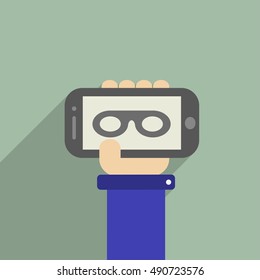 Hand holding a phone with Mask glasses