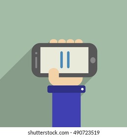 Hand holding a phone with stop
