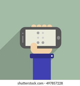 Hand holding a phone with "U" letter in Braille