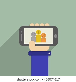 Hand holding a phone whith Pedestal with medals