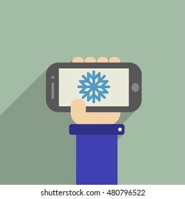 Hand holding a phone whith Snowflake