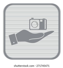 hand holding a photo camera