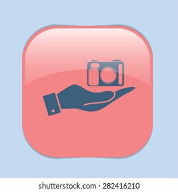 hand holding a photo camera