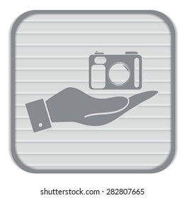 hand holding a photo camera