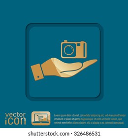 hand holding a photo camera