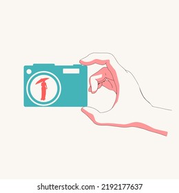 Hand holding photo camera icon with woman silhouette