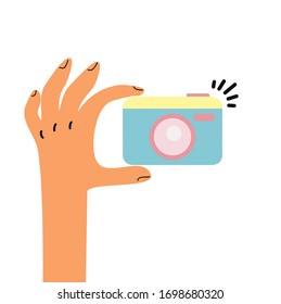 Hand, die eine Fotokamera-Vektorillustration hält