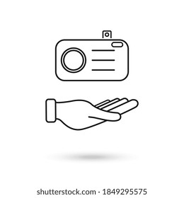 Hand holding a photographic camera icon over white background. Vector Illustration