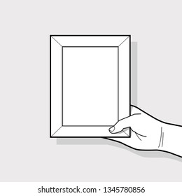 Hand Holding Picture Frame.
