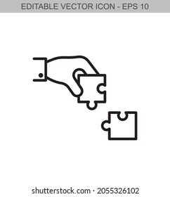 Hand holding a piece of puzzle. Editable line icon.