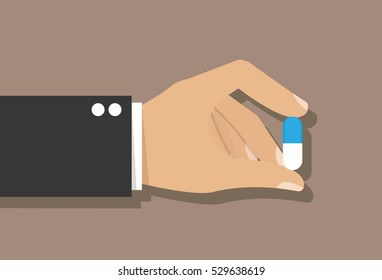 Hand holding a pill