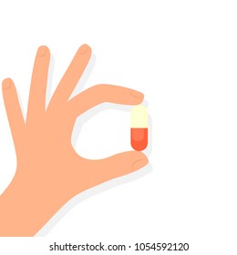 Hand holding pill. Vector image isolated on white background