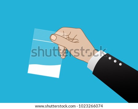 Hand holding plastic bag filled with white powder
