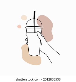 Hand holding a plastic disposable transparent cup on white background.