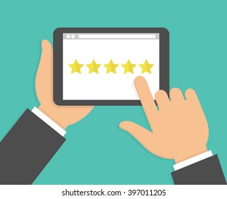 Hand Holding And Pointing To A Tablet With Five Star On The Screen. Rating And Review Concept. Flat Design