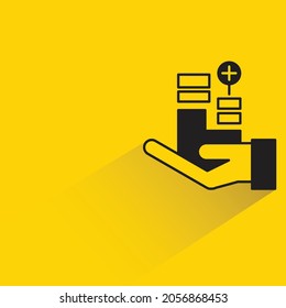 hand holding positive chart with shadow on yellow background