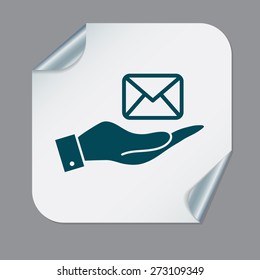 hand holding a postal envelope sign. e-mail symbol . icon envelope.