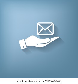 hand holding a postal envelope sign. e-mail symbol . icon envelope.