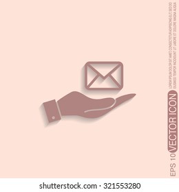 hand holding a postal envelope sign. e-mail symbol . icon envelope.