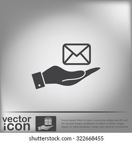 hand holding a postal envelope sign. e-mail symbol . icon envelope.