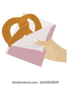 hand holding pretzel. holding a pretzel.