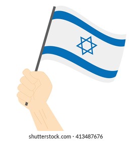 Hand Holding And Raising The National Flag Of Israel