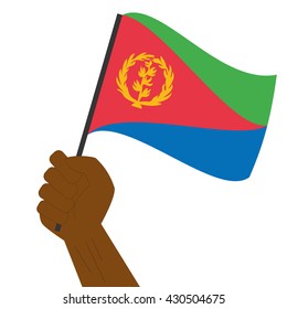 Hand holding and raising the national flag of Eritrea