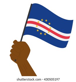 Hand holding and raising the national flag of Cape Verde