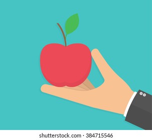 Hand holding a red apple. Flat design