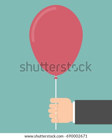 Hand holding a red balloon