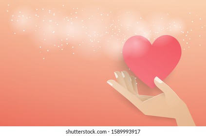 Hand holding a red heart floating out of the envelope with a white spray on the pink background