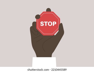 A hand holding a red octagonal stop sign, restricted actions, no racism policy