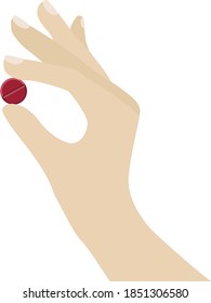Hand holding a red pill