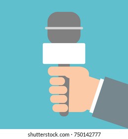 Hand holding reporter microphone