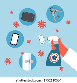 Hand holding sanitizer bottle spraying on mobile phone, wallet, key and door knob. Coronavirus disease prevention. Disinfect Covid-19 personal healthcare concept.