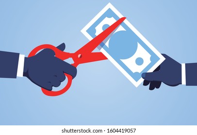 Hand holding scissors to cut banknotes