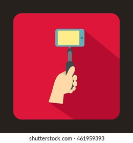 Hand holding a selfie stick with mobile phone icon in flat style with long shadow. Device symbol
