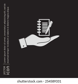 hand holding a sheet of paper and pen