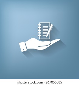 hand holding a sheet of paper and pen