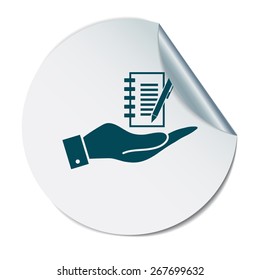 hand holding a sheet of paper and pen