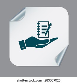 hand holding a sheet of paper and pen
