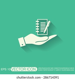hand holding a sheet of paper and pen
