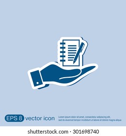 hand holding a sheet of paper and pen