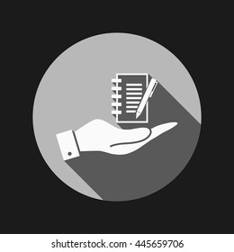 hand holding a sheet of paper and pen