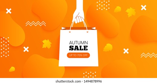 Hand holding shopping bag. Autumn sale. Fall background. Vector